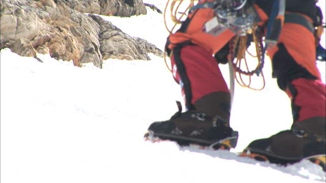 Climbers Progressing Through Snowy Terrain