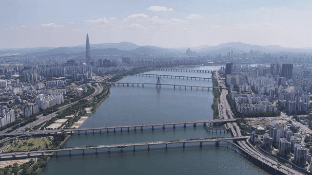 Panoramic view of large city with river and bridge