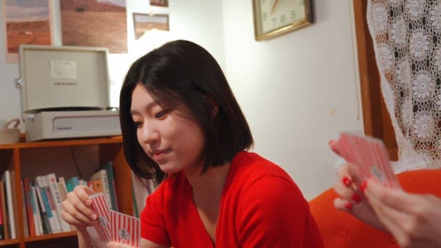 Friends playing cards in a cozy room