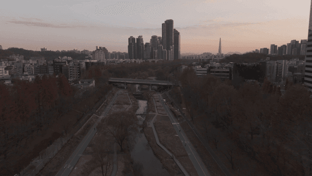Cityscape with river and high-rise buildings.