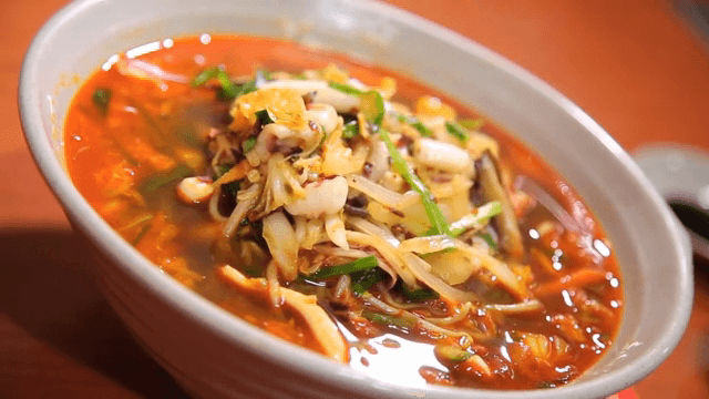 Spicy seafood noodle soup on a table