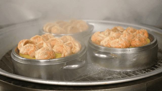 Kimchi dumplings steamed in large steamer