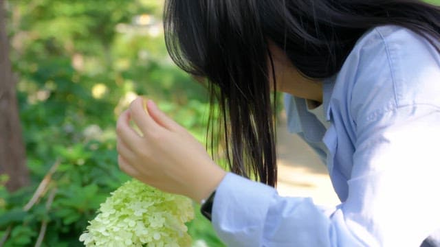 Woman enjoying the scent of flowers