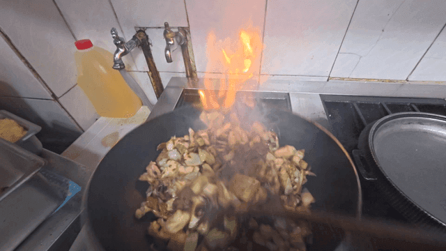 Stir-frying vegetables and meat in a pan