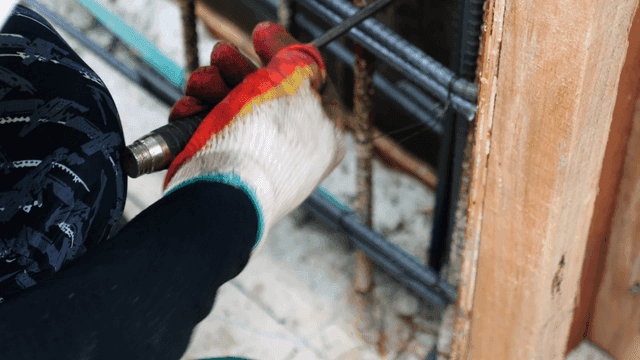 Worker tying rebar at a construction site