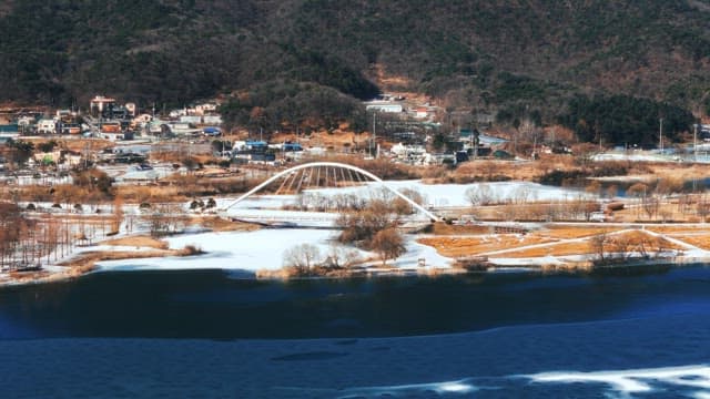 Winter scene with bridge over frozen river