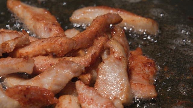 Pork neck sizzling on a hot pan