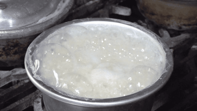 Rice boiling in a pot on a stove