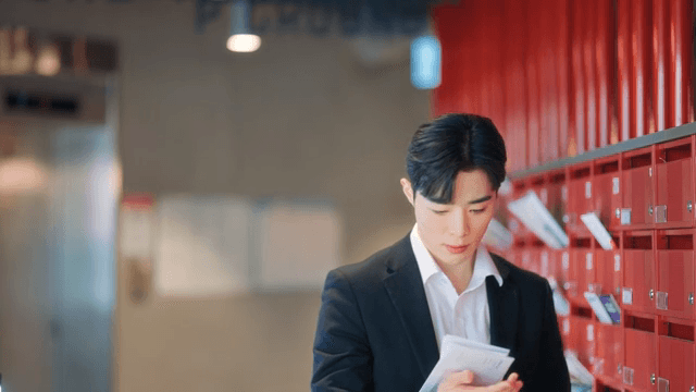 Man checking mail at red mailbox