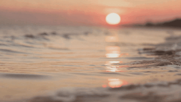 Waves gently rolling at sunset