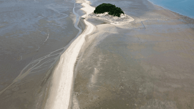 Sandy path leading to small island