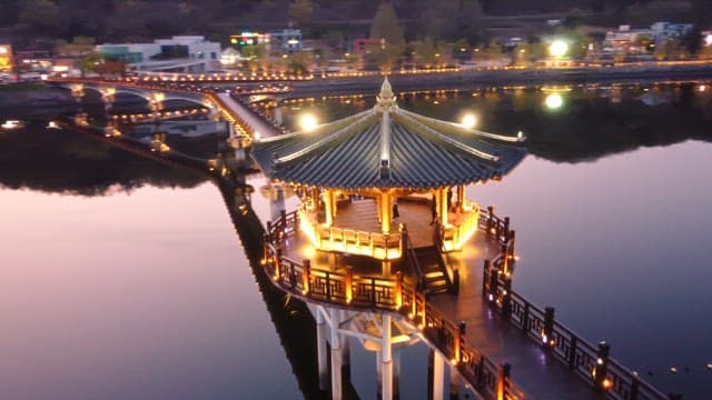 Illuminated pavilion on a serene river