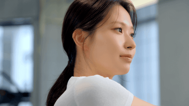 Young woman stretching indoors with focus