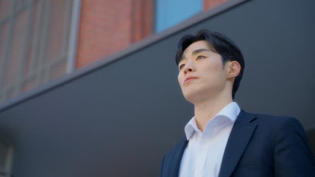 Man standing in front of a red building