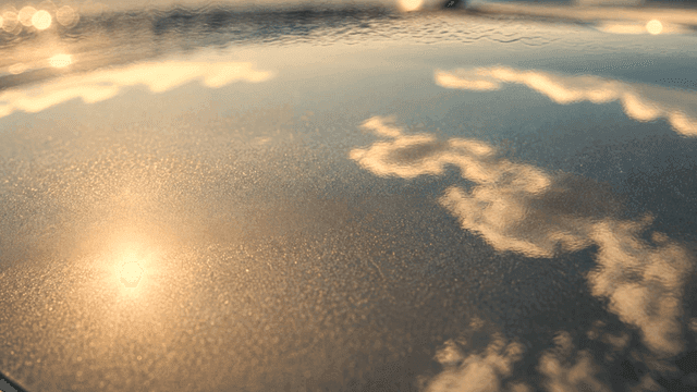 Reflection of clouds and sunlight on water
