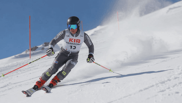 A skier racing down a snowy slope