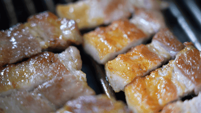 Grilled pork belly on a hot grill