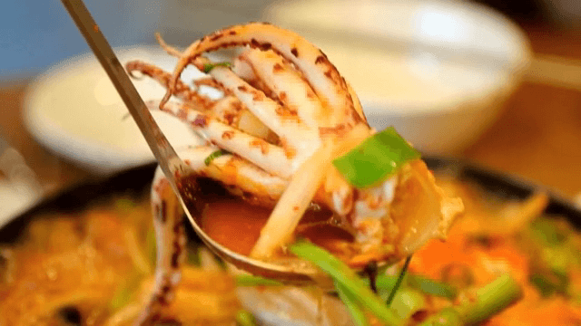 Bubbling pot of Spicy Seafood Stew with squid