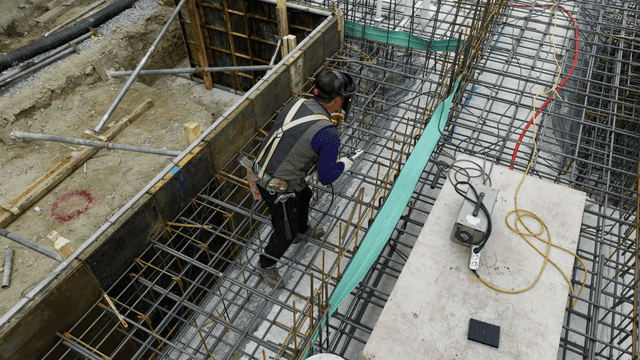 Construction worker welding rebar
