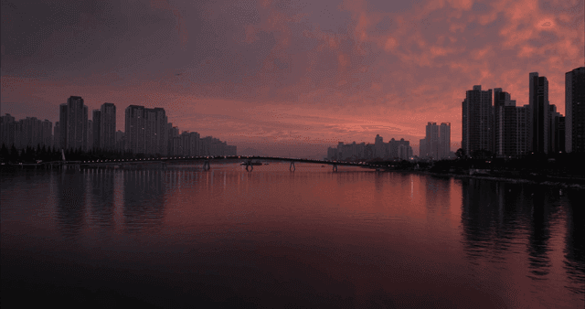 City skyline at sunset with a river view