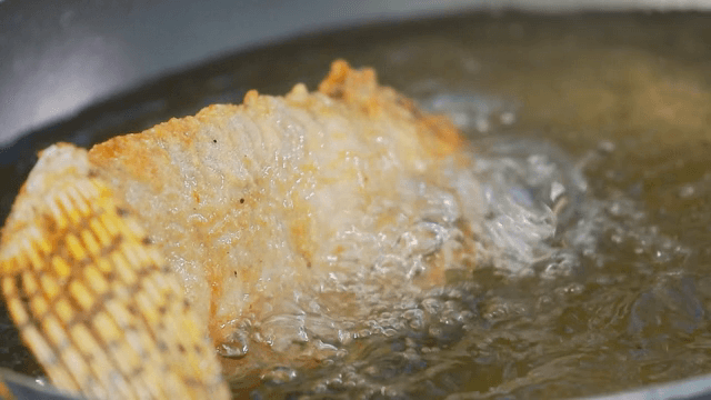 Golden fried fish in hot oil