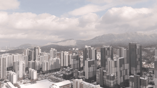 Snow-covered cityscape with mountains