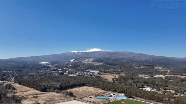 Vast landscape with a snow-capped mountain