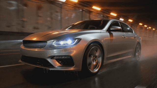 Car driving through dark tunnel