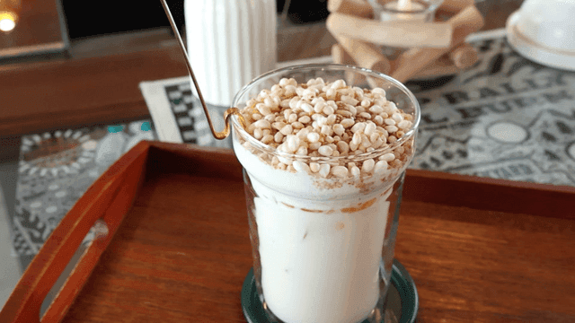 Cup of latte topped with grains