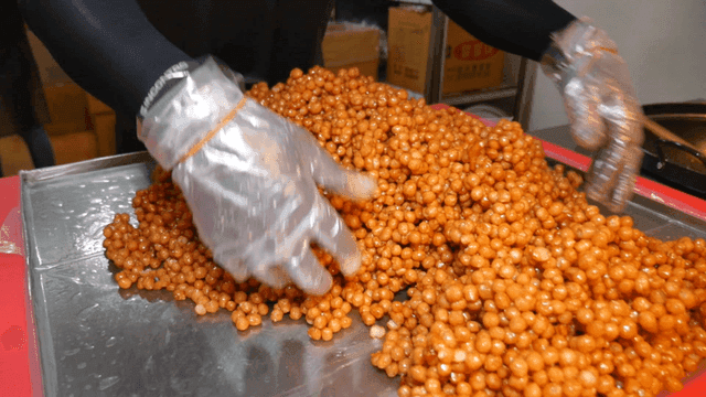 Gloved hands arranging sweet treats