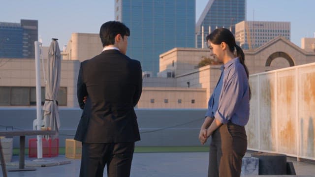 Two colleagues talking on a rooftop