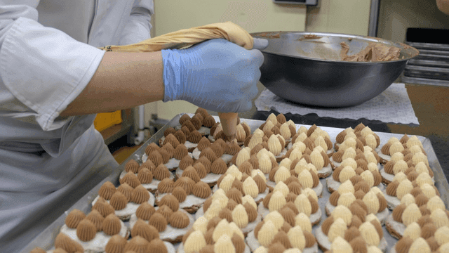 Chef decorating desserts with cream