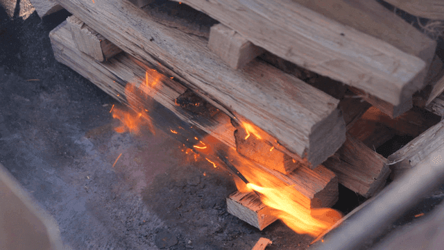 Wood fire heating a large cooking pan