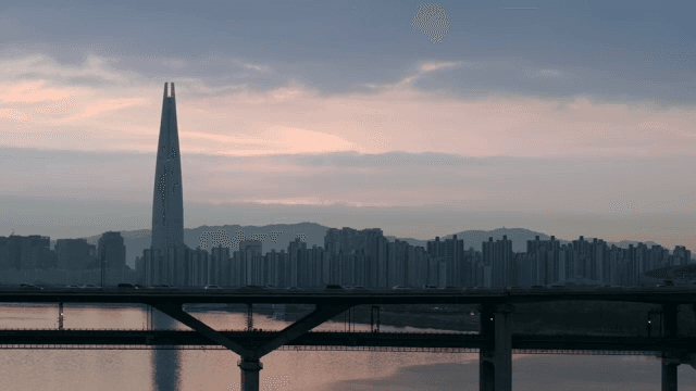City skyline with a tall tower at dusk