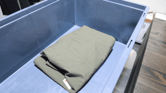 Person folding clothes on table