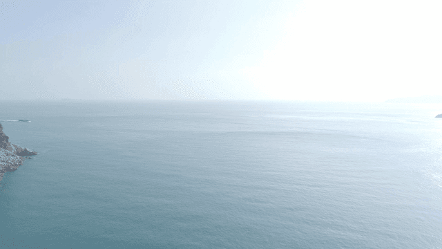 Vast ocean with distant cliffs