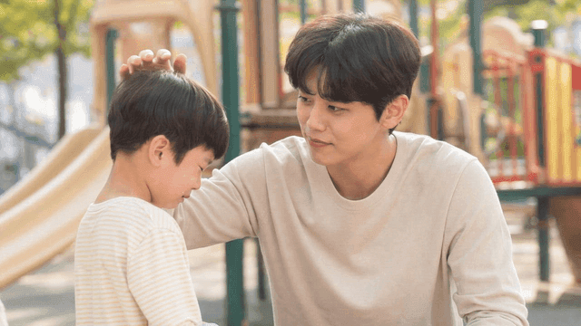 Man comforting crying child at playground