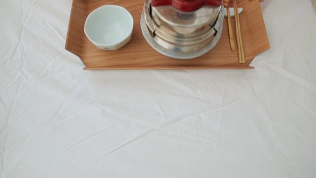 Tray of rice cooked in a pot with Korean side dishes such as kimchi