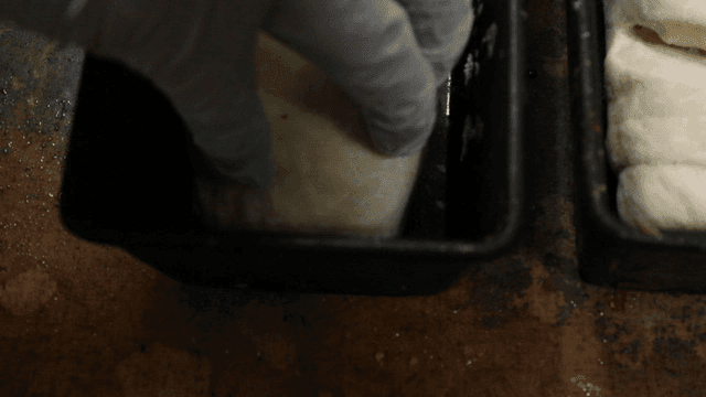 Dough being placed into a baking pan