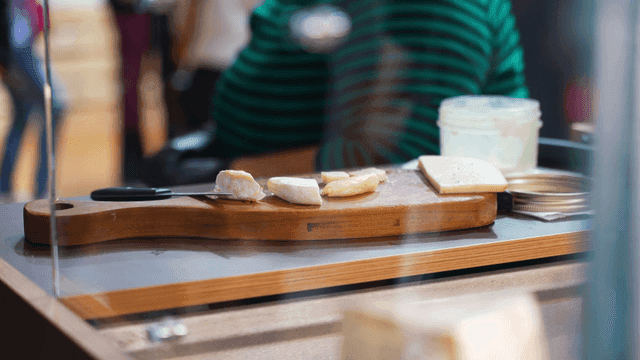 Cheese slices on a wooden board