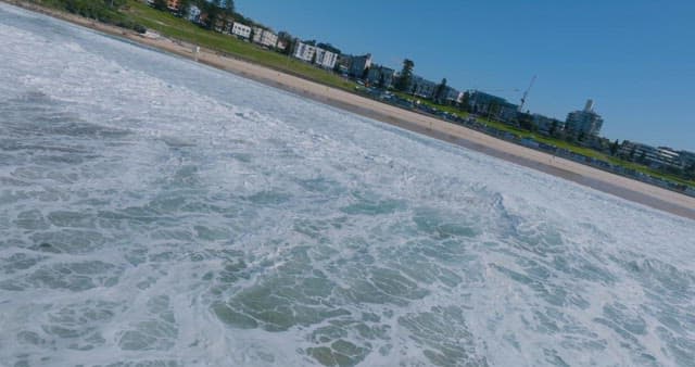 Crashing Waves as they Approach the Coastal City Beach