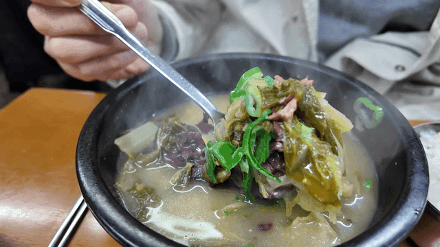 Hot seonji hangover soup with cabbage in earthenware bowl