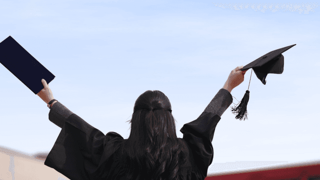 Graduates celebrating with their caps and diplomas