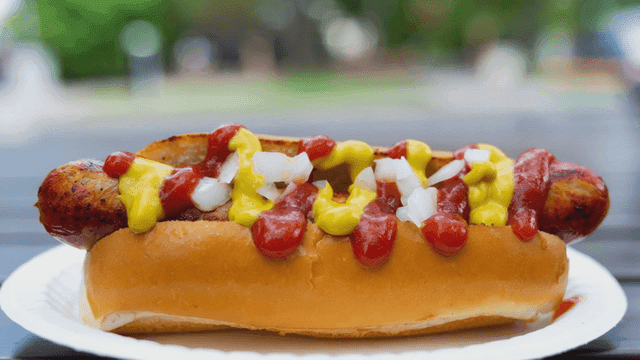 Hot dog topped with mustard and ketchup