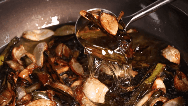 Vegetables frying in hot oil in a pan