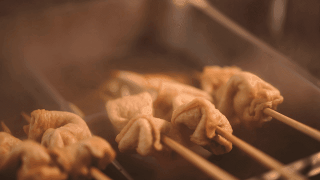 Fish cake skewers boiling in broth