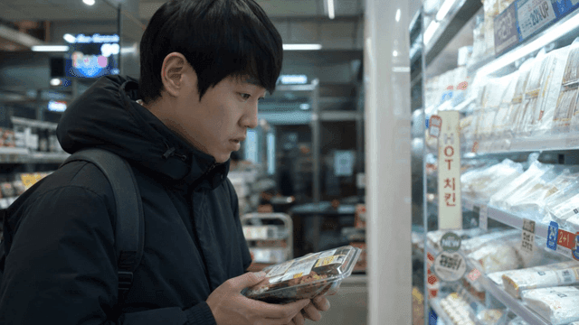 Man choosing lunchbox at convenience store