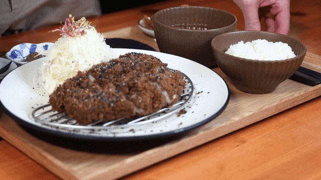 Black pork cutlet served on tray