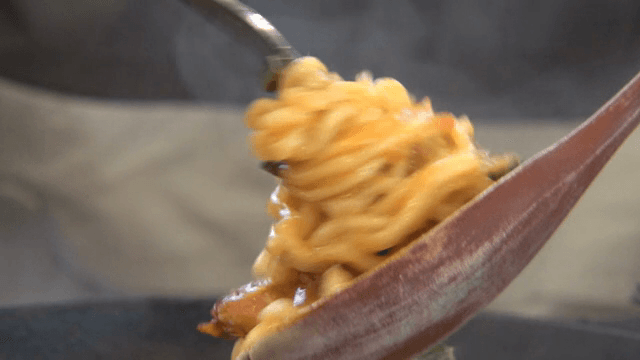A scene of ramyeon being rolled on a fork