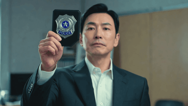Man in suit showing off his police badge